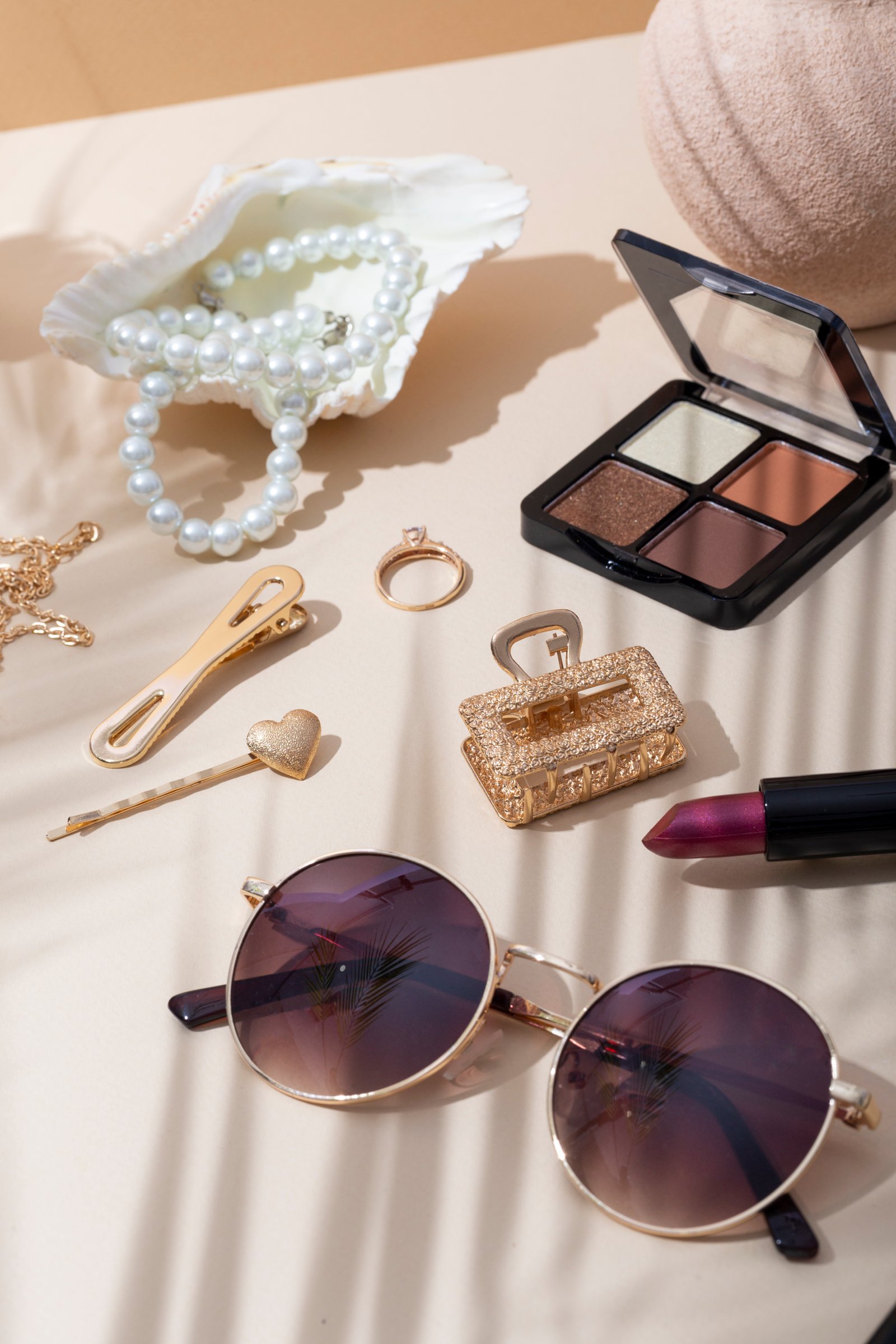 Makeup products and jewelry flat lay